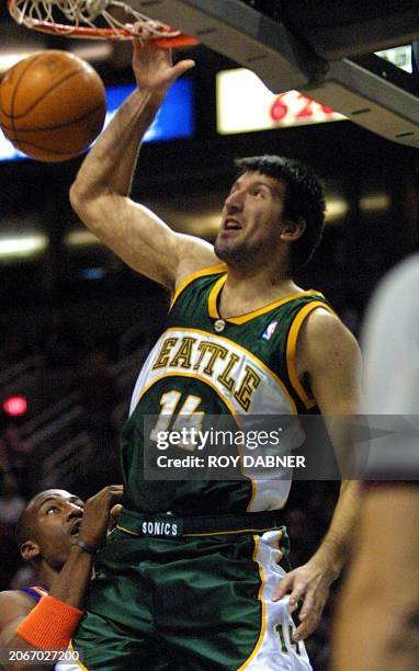 Phoenix Suns Stephon Marbury defends as Seattle Supersonics Predrag Potapenko of Yugoslavia slams for two points during the first quarter, 23...