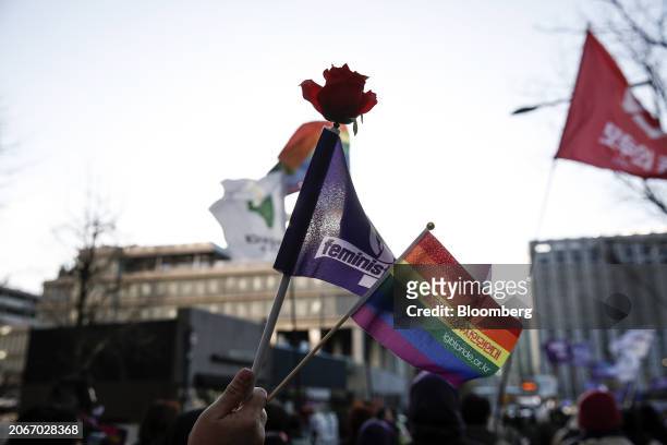 Demonstrator holds flags during the Women's Day march in Seoul, South Korea, on Friday, March 8, 2024. Every March 8, women across the globe rally to...