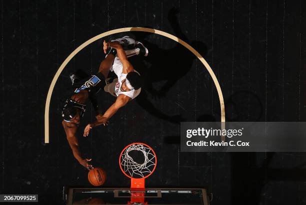 Bruno Fernando of the Atlanta Hawks drives against Jarrett Allen of the Cleveland Cavaliers during the first quarter at State Farm Arena on March 06,...