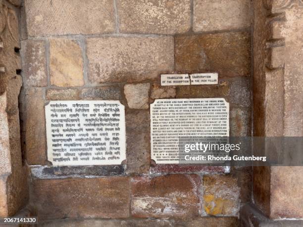 translation and transcription of the inscription on the iron pillar, qutub minar complex, lal kot, delhi, india - iron pillar new delhi stock pictures, royalty-free photos & images