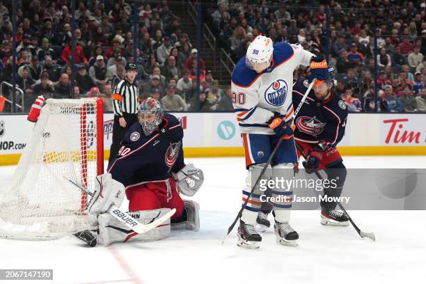 Corey Perry of the Edmonton Oilers deflects the puck past Daniil Tarasov of the Columbus Blue Jackets into the back of the net during the third...