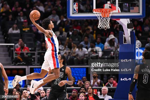 Ausar Thompson of the Detroit Pistons dunks after the whistle against the Brooklyn Nets during the second half at Little Caesars Arena on March 07,...