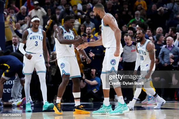 Anthony Edwards and Rudy Gobert of the Minnesota Timberwolves celebrate after beating the Indiana Pacers 113-111 at Gainbridge Fieldhouse on March...