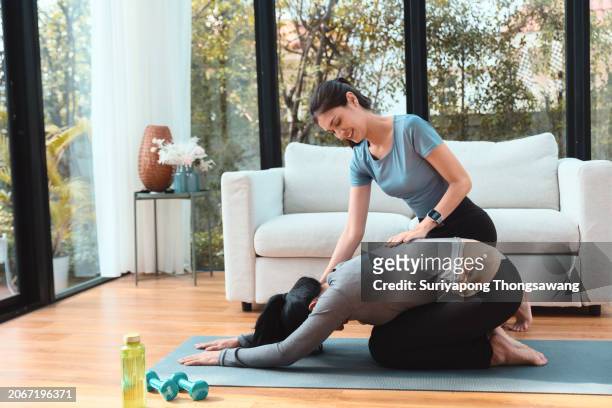 daughter and mother doing exercise or yoga in living room at home. healthy lifestyle or sports training concept. - flatten the curve imagens e fotografias de stock