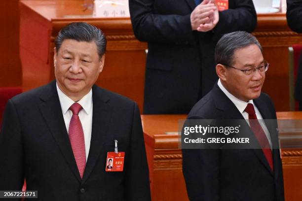 China's President Xi Jinping and China's Premier Li Qiang arrive for the closing session of the 14th National People's Congress at the Great Hall of...