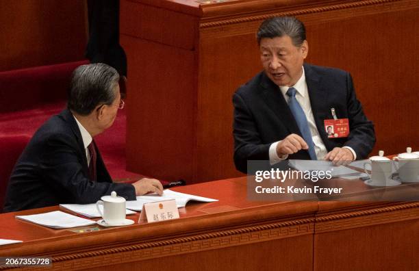 Chinese President Xi Jinping speaks to NPC Chairman Zhao Leji during the second plenary session of the NPC, or National People's Congress, at the...