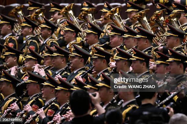 Members of the Police Liberation Army's band rehearse ahead of the closing ceremony of the 14th National People's Congress at the Great Hall of the...