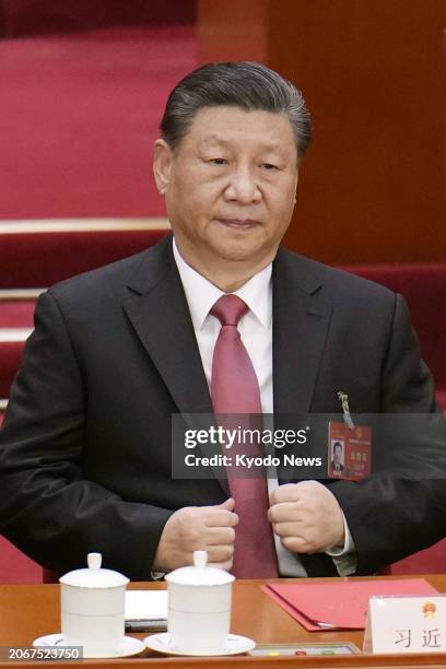 Chinese President Xi Jinping attends the closing ceremony of the National People's Congress at the Great Hall of the People in Beijing on March 11,...