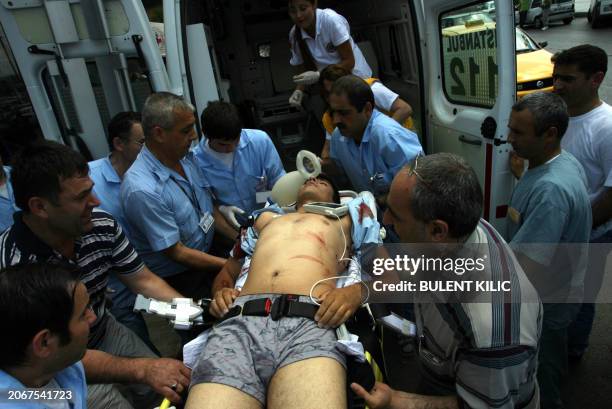 Medics tend to a victim outside the US consulate in Istanbul on July 9 after three unidentified gunmen and three Turkish policeman were killed in an...