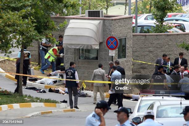 Unidentified men lie on the ground lifeless after an attack outside the US consulate in Istanbul on July 9, 2008. Three unidentified gunmen and three...