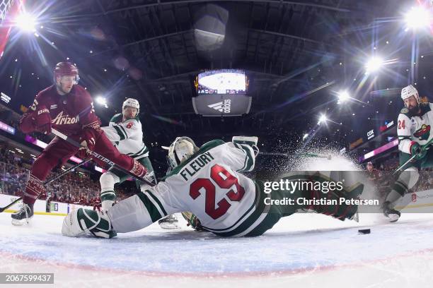 Goaltender Marc-Andre Fleury of the Minnesota Wild makes a save on Alex Kerfoot of the Arizona Coyotes during the second period of the NHL game at...