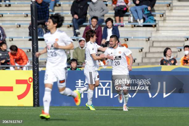 Takuma Abe of Vegalta Sendai celebrates with teammate Naoki Ishihara after scoring the team's first goal during the J.League J1 match between Shimizu...