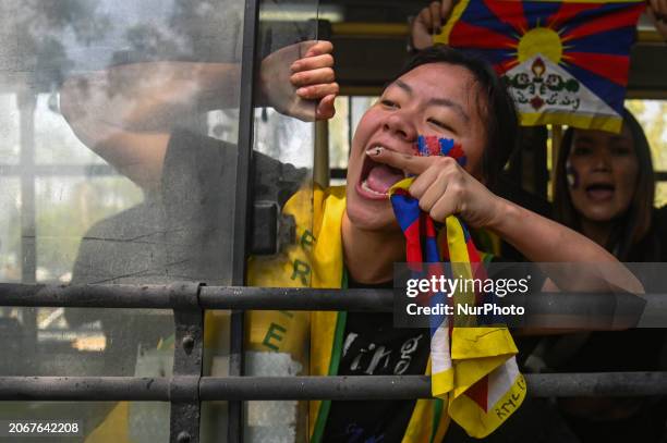 Tibetan activist from the Tibetan Youth Congress is shouting slogans as she is being detained during a protest to mark the anniversary of the 65th...