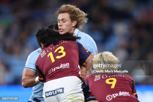 Ned Hanigan of the Waratahs is tackled during the round three Super Rugby Pacific match between NSW Waratahs and Highlanders at Allianz Stadium, on...