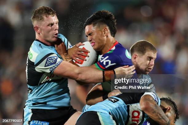 Taine Tuaupiki of the Warriors is tackled during the round one NRL match between New Zealand Warriors and Cronulla Sharks at Go Media Stadium Mt...