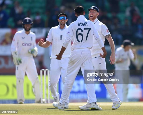 Shoaib Bashir of England celebrates with captain Ben Stokes after taking the wicket of Sarfaraz Khan of India during day two of the 5th Test Match...