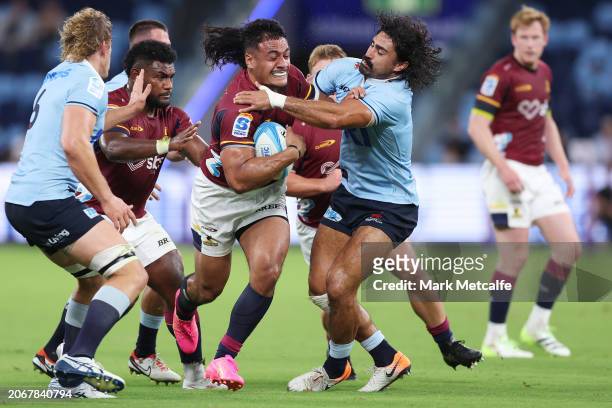 Tanielu Tele’a of the Highlanders is tackled during the round three Super Rugby Pacific match between NSW Waratahs and Highlanders at Allianz...