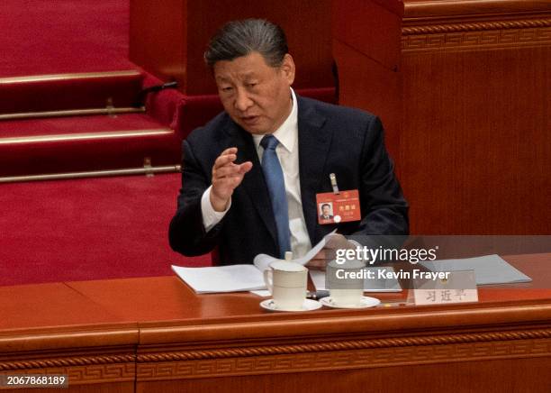 Chinese President Xi Jinping speaks to NPC Chairman Zhao Leji, not seen, at the second plenary session of the National Peoples Congress at the Great...