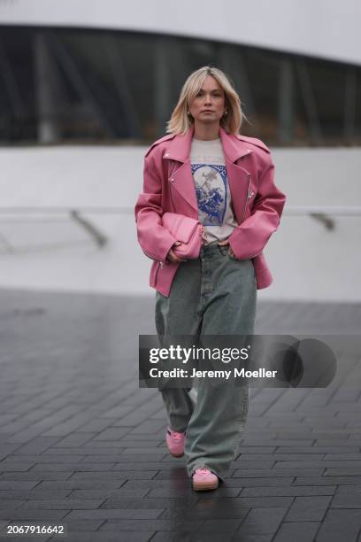 Nadine Berneis seen wearing The Frankie Shop pink oversized leather jacket, Acne Studios off-white / blue print pattern graphic cotton t-shirt, Acne...