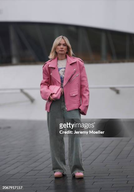 Nadine Berneis seen wearing The Frankie Shop pink oversized leather jacket, Acne Studios off-white / blue print pattern graphic cotton t-shirt, Acne...