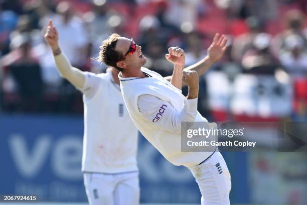 Tom Hartley of England celebrates with captain Ben Stokes after taking the wicket of Ravindra Jadeja of India during day two of the 5th Test Match...