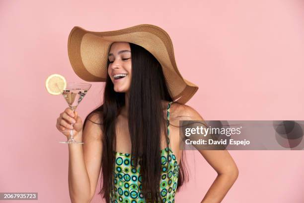 joyful woman celebrating with cocktail - david swallow stock pictures, royalty-free photos & images