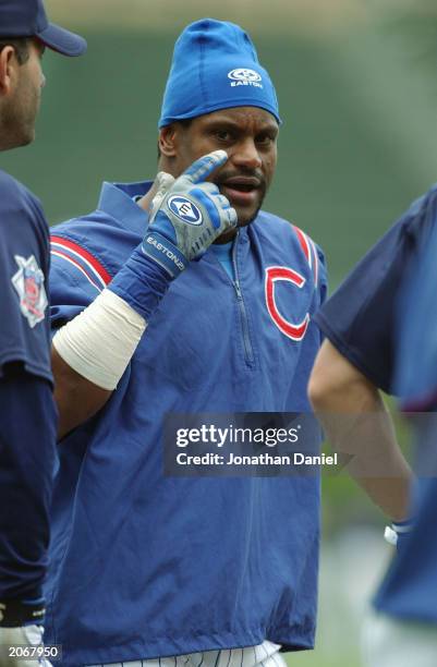 Right fielder Sammy Sosa of the Chicago Cubs talks with teammates during batting practice prior to the game against the Tampa Bay Devil Rays at...