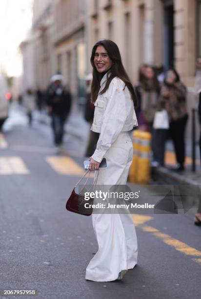 Belen Hostalet was seen wearing brown bag, cropped white jeans jacket as well as white denim jeans outside before Zimmermann Fashion Show during the...