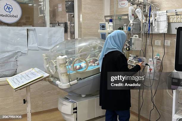 Newborn baby with feeding problems is seen receiving treatment at Kamal Adwan Hospital under harsh conditions due to lack of access to medicines, and...