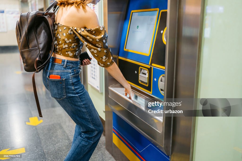 Young Woman Buying Train Tickets At The Train Station In Bangkok In Thailand