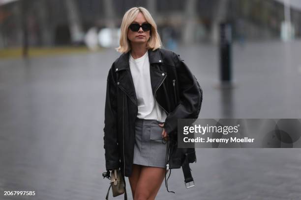 Nadine Berneis seen wearing Kapten & Son black sunglasses, silver / gold earrings, Young Poets black oversized leather jacket, Zwingenberg Studio...