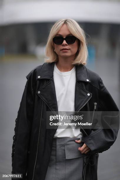 Nadine Berneis seen wearing Kapten & Son black sunglasses, silver / gold earrings, Young Poets black oversized leather jacket, Zwingenberg Studio...