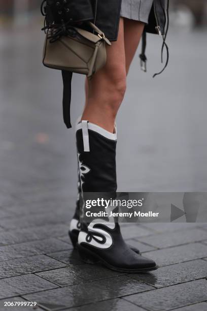 Nadine Berneis seen wearing Young Poets black oversized leather jacket, Zwingenberg Studio grey short skirt, Loewe beige leather Puzzle mini bag and...