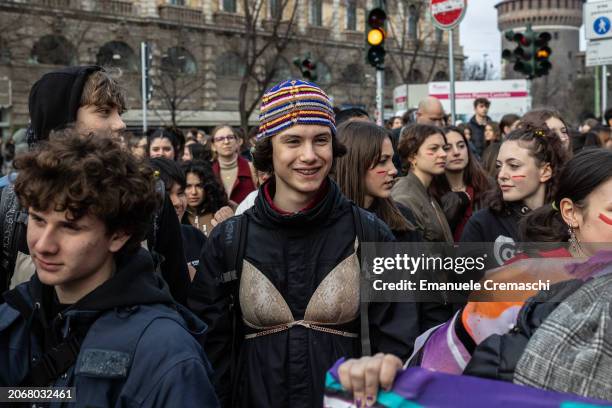 Young man wearing a bra smiles as he takes part in a rally, demonstrating against Patriarchy and violence, on March 08, 2024 in Milan, Italy. Festa...