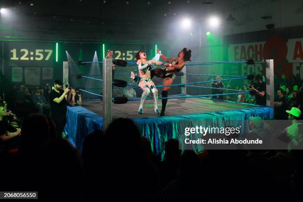 Members of the audience watch as wrestlers, Tae Honma and Alex Windsor, perform during their wrestling match on March 8, 2024 in London, England. Eve...
