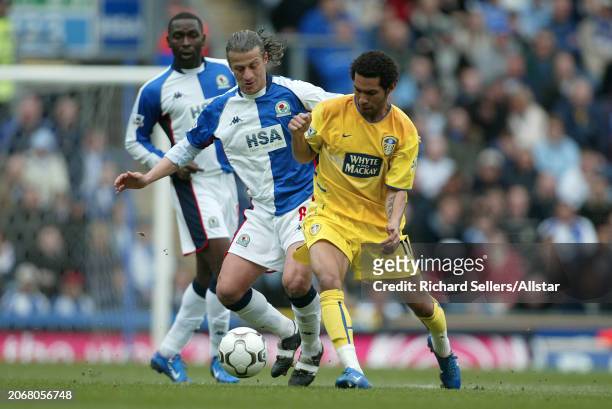 April 10: Jermaine Pennant of Leeds United and Tugay of Blackburn Rovers challenge during the Premier League match between Blackburn Rovers and Leeds...