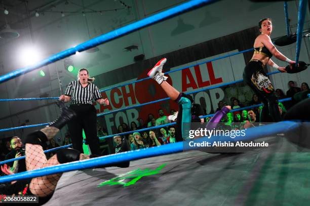 Members of the audience react as they watch wrestlers perform during the all female wrestling event on March 8, 2024 in London, England. Eve was...