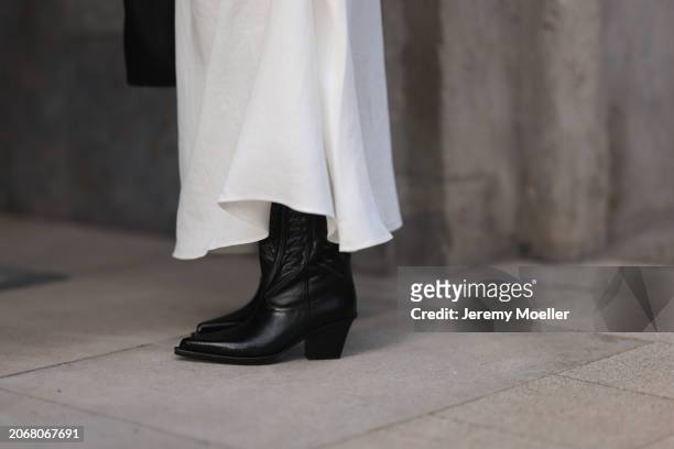 Aylin Koenig seen wearing By Aylin Koenig white bandeau long dress and Paris Texas black leather cowboy boots, on March 07, 2024 in Hamburg, Germany.