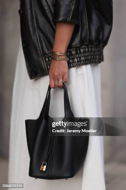 Aylin Koenig seen wearing Miu Miu black oversized leather jacket, By Aylin Koenig white bandeau long dress, Hermès Picotin black leather bag, Cartier...