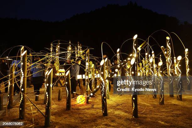 People look at lanterns placed at Okawa Elementary School in Ishinomaki in Miyagi Prefecture, northeastern Japan, on March 11 the 13th anniversary of...