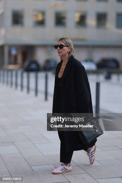 Aylin Koenig seen wearing Saint Laurent black sunglasses, Cartier Love gold yellow necklace, Ole Lynggaard elephant yellow gold necklace, black knit...