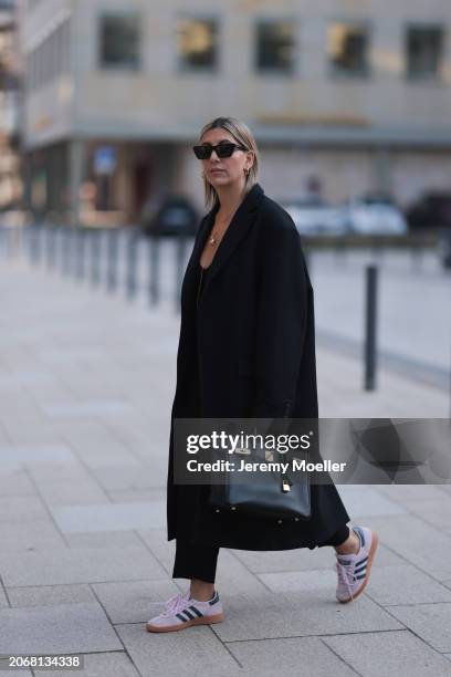 Aylin Koenig seen wearing Saint Laurent black sunglasses, Cartier Love gold yellow necklace, Ole Lynggaard elephant yellow gold necklace, black knit...