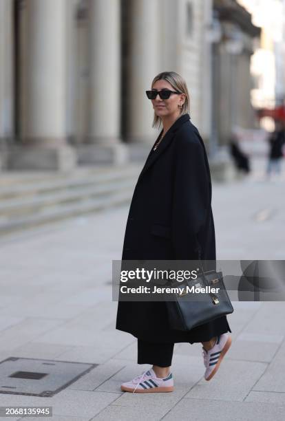 Aylin Koenig seen wearing Saint Laurent black sunglasses, Zara black fabric long pants, By Aylin Koenig black wool long coat, Hermès Birkin black...