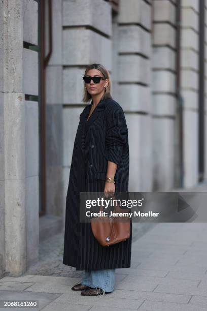 Aylin Koenig seen wearing Celine black sunglasses, gold earrings, By Aylin Koenig black pinstriped oversized long coat, Zara light blue wide leg...