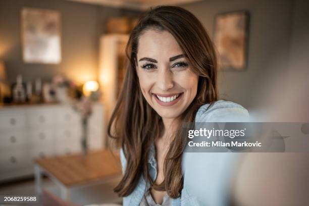 beautiful young woman, a social media influencer recording a video - selfie stock pictures, royalty-free photos & images