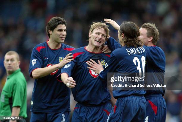 March 27: Teddy Sheringham, Alex Smertin, Dejan Stefanovic and Matthew Taylor of Portsmouth celebrate during the Premier League match between...