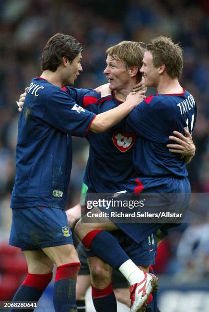 March 27: Teddy Sheringham, Dejan Stefanovic and Matthew Taylor of Portsmouth celebrate during the Premier League match between Blackburn Rovers and...