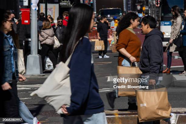 Shoppers carry Uniqlo bags in the SoHo neighborhood of New York, US, on Friday, March 8, 2024. The US Census Bureau is scheduled to release retail...