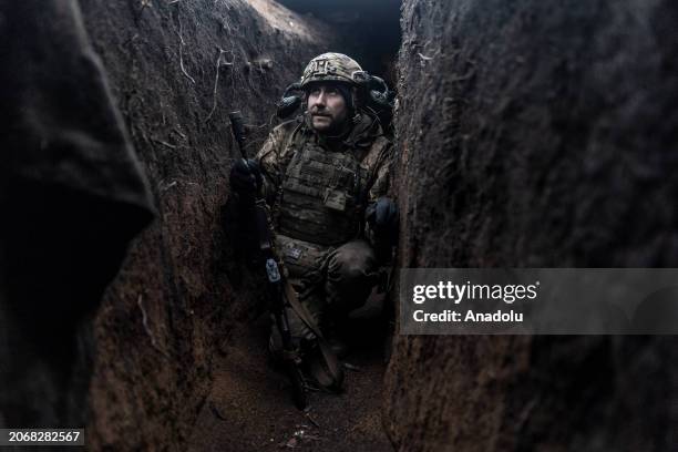 Ukrainian soldier crouching in a trench in his infantry position as the Russia-Ukraine war continues in the direction of Kupiansk, Kharkiv Oblast,...