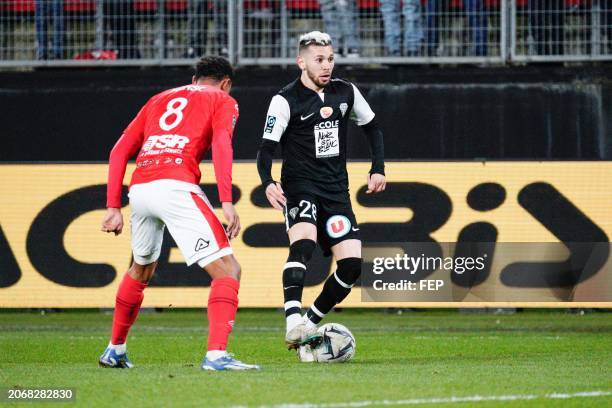 Farid El Melali of Angers takes on Sacha Banse of Valenciennes during the Ligue 2 BKT match between Valenciennes and Angers at Stade du Hainaut on...